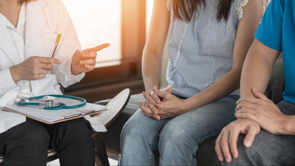 a doctor discussing fertility with a couple